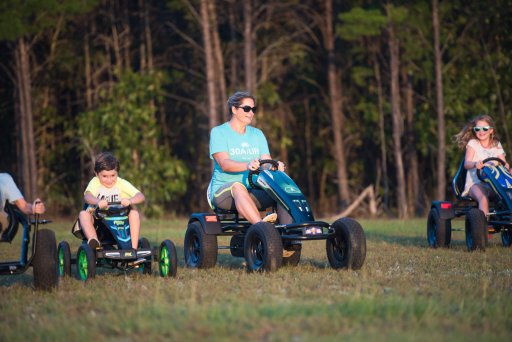 Mom and kids riding the Prime Karts XL-4 Agri-Trac and Racer karts